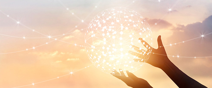 Hands holding a glowing ball